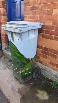 Wheelie bin painted with picture of Glastonbury Tor