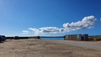 view across car park to sea. blue sky