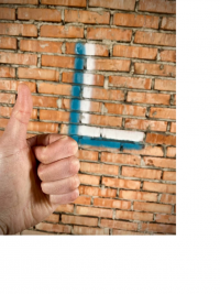 white and blue L symbol painted on wall, hand giving thumbs up in foreground.png