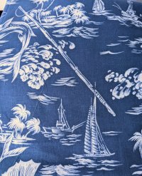 Blue fabric with white palm trees and marlins in an ornate style 