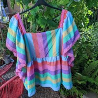 A fluttery top with broad pink, purple, blue, green, orange and yellow stripes. 