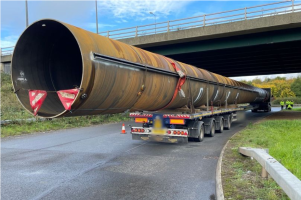 vast metal pipe longer than long vehicle