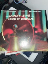 The Ramsay Lewis Sound of Christmas: a CD cover on top of a pile of CDs. 