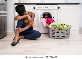 A housewife sits and weeps about the laundry