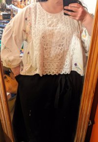 Another view of the blouse showing voluminous sleeves and accompanying black skirt 