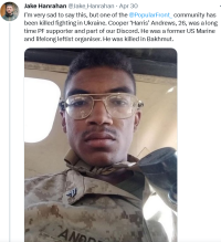 young Black man wearing glasses in military garb