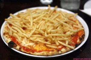 A pizza with chips on top. 