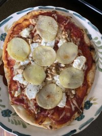 Homemade potato pizza with goat’s cheese and walnuts.