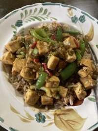 Tofu stir fried with broccoli, sugar snap peas, ginger, Chili, five spice, soy sauce, rice vinegar, and served on whole meal rice. 