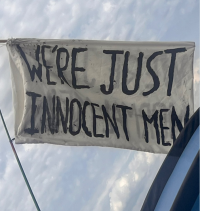 WE'RE JUST INNOCENT MEN home-made flag at Glasto