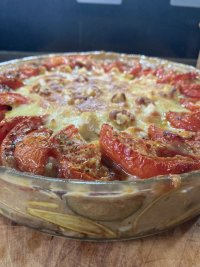 A crispy topped vegetable pasta bake glistens with deliciousness.