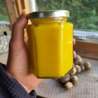 Picture of a jar of very bright yellow lemon curd