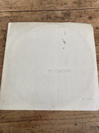 A time worn Beatles White Album with dog ears and stains.