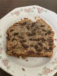 A slice of fruit cake on a tea plate. 