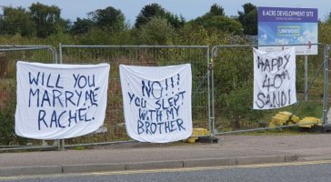 A bed sheet has “will you marry me Rachel?” The reply says “No!! You slept with my brother”.  