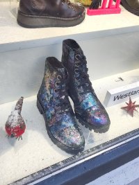 Photo of some multicoloured metallic boots in a similar style to six hole doc martens