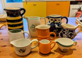 A group of 9 jugs of various sizes and colours