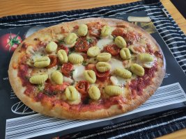 A Margherita pizza with gnocchi added to the toppings 