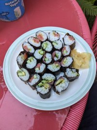 a plate of sushi cut rolls