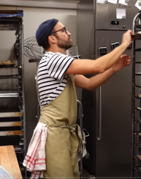 a baker in Sweden wearing a black and white stripey top