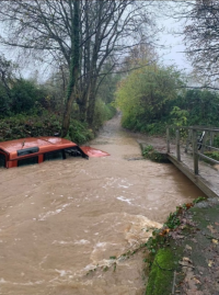 Land rover stuck in flood water nearly up to its roof.