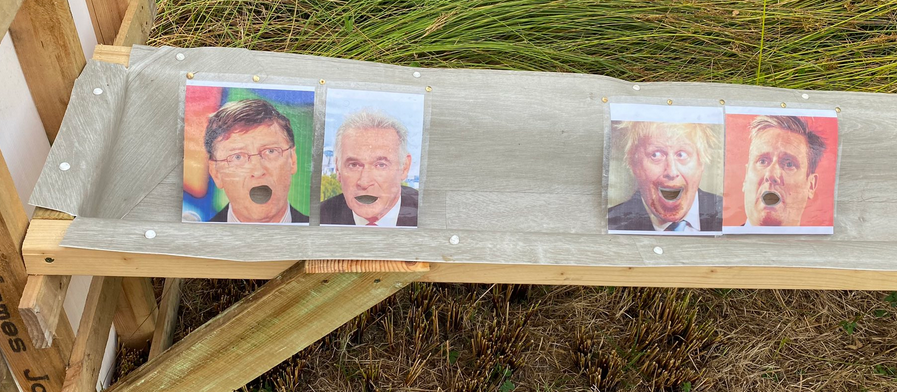 Close-up of pictures of politicians heads in the urinals.