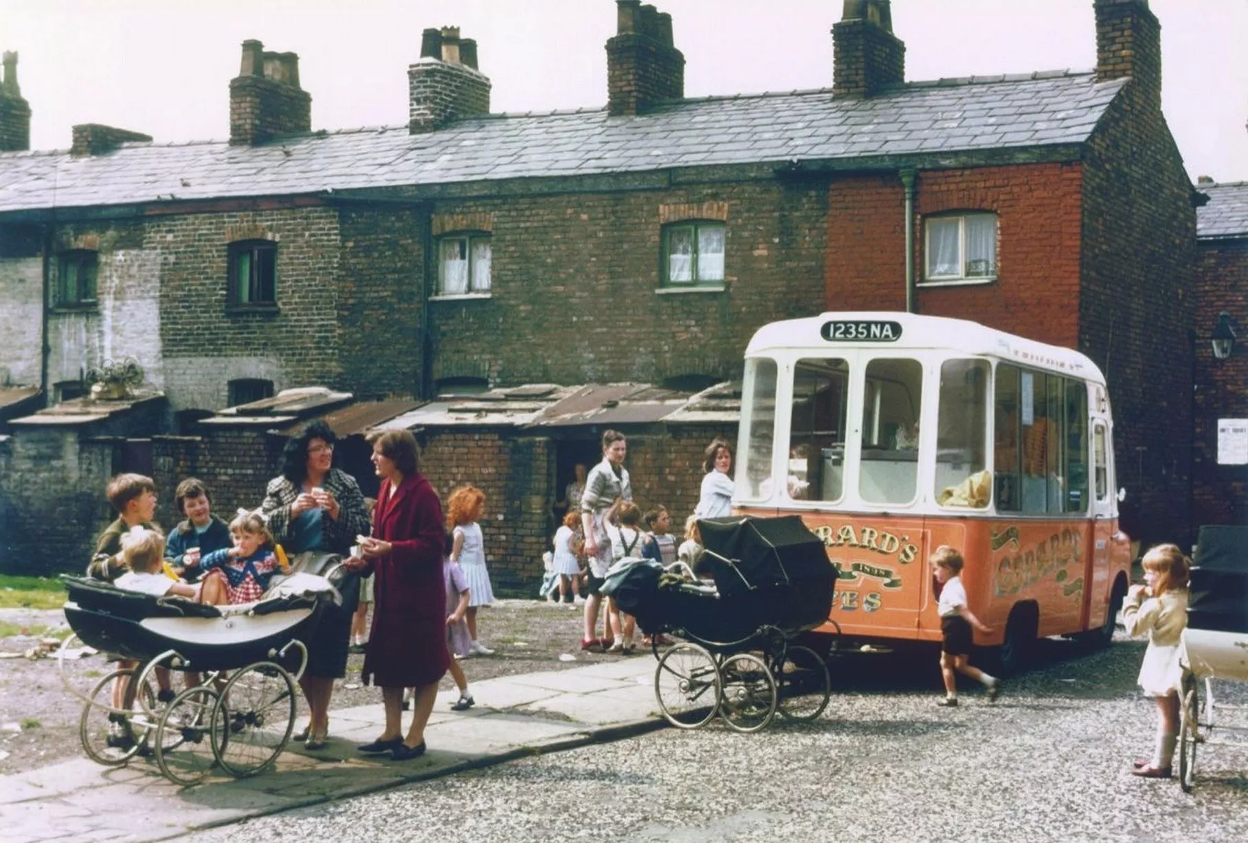 mothers and children buying ice cream from a van in Hulme, 1965