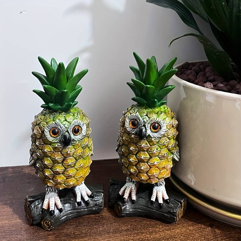two pineapple owls stood on logs