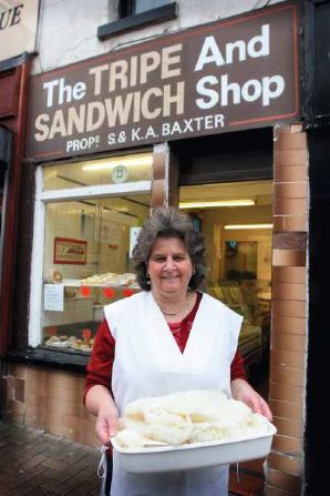 the tripe and sandwich shop, Stalybridge, with owner standing outside with a tray full to the brim of glistening tripe