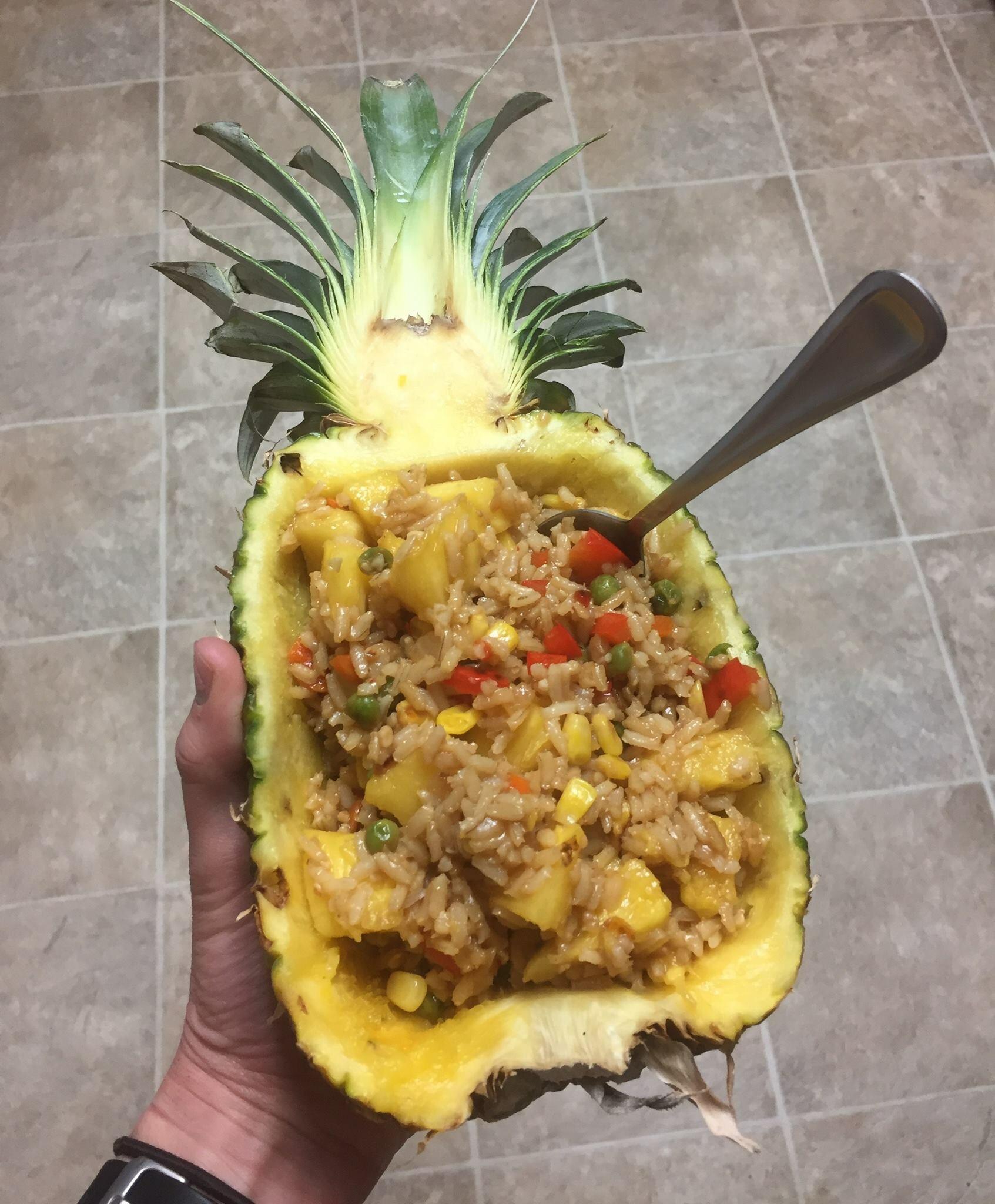 a rice dish served in a hollowed-out pineapple shell