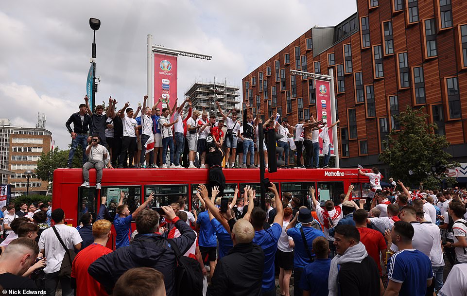 45301649-9777235-England_supporters_at_Wembley_clamber_onto_a_bus_ahead_of_the_Th-m-846_1626011378381.jpg