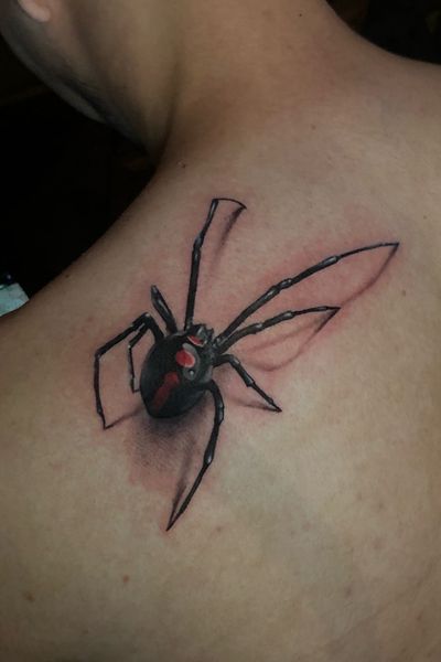 a person with a spider tattoo on their shoulder