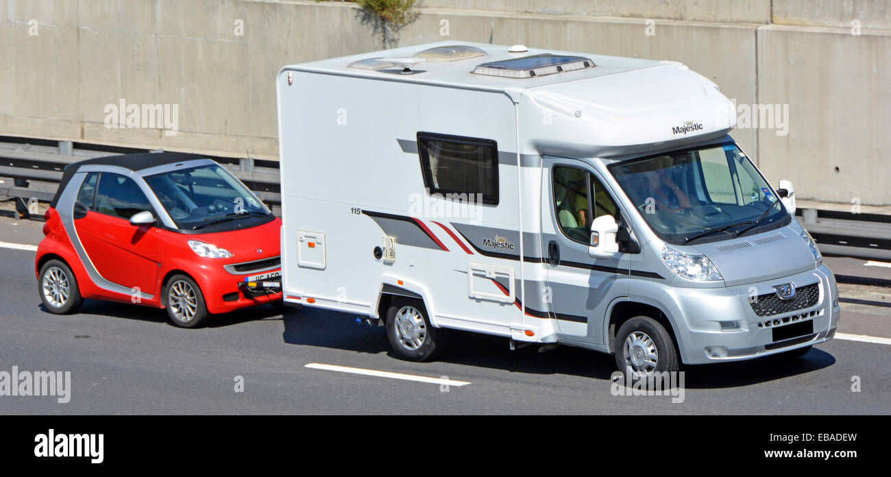 side-front-view-of-rv-camper-van-motorhome-recreational-vehicle-towing-EBADEW.jpg