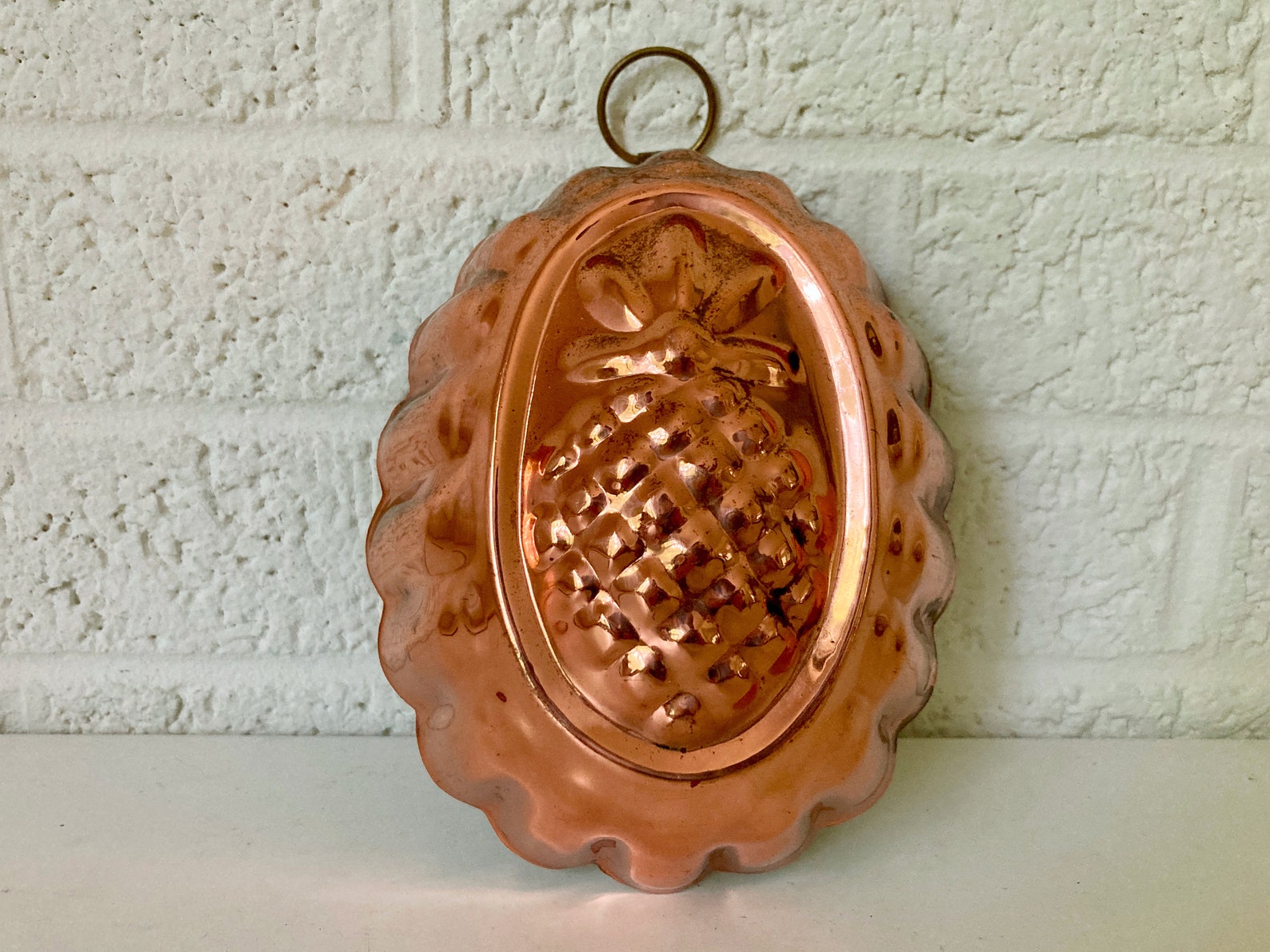 vintage copper baking tin or jelly mould with a pineapple embossed on to the top
