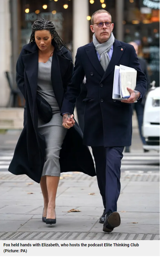 Lozza Fox holds hands with Elizabeth ‘Liz’ Barker of the 'Elite Thinking Podcast' as they enter the Royal Courts of Justice