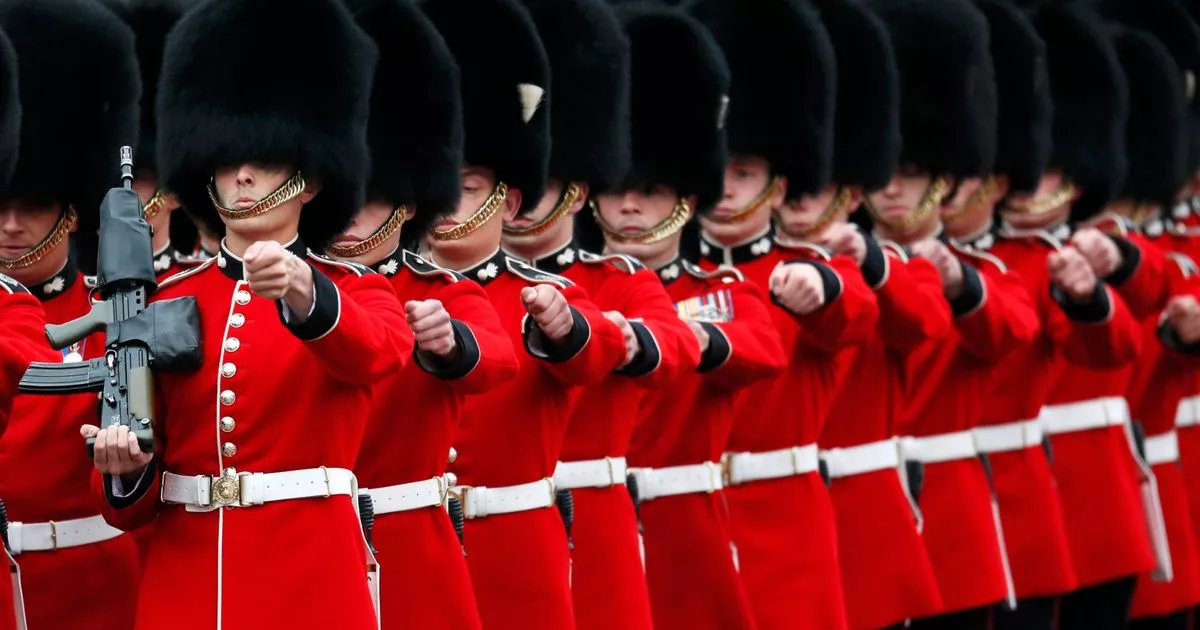 Guardsmen-march-past-Buckingham-Palace.jpg