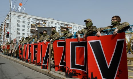 Demonstrators in military uniform hold placards forming the words 'Free Azov' during a rally calling on authorities to return their relatives from Russian captivity.
